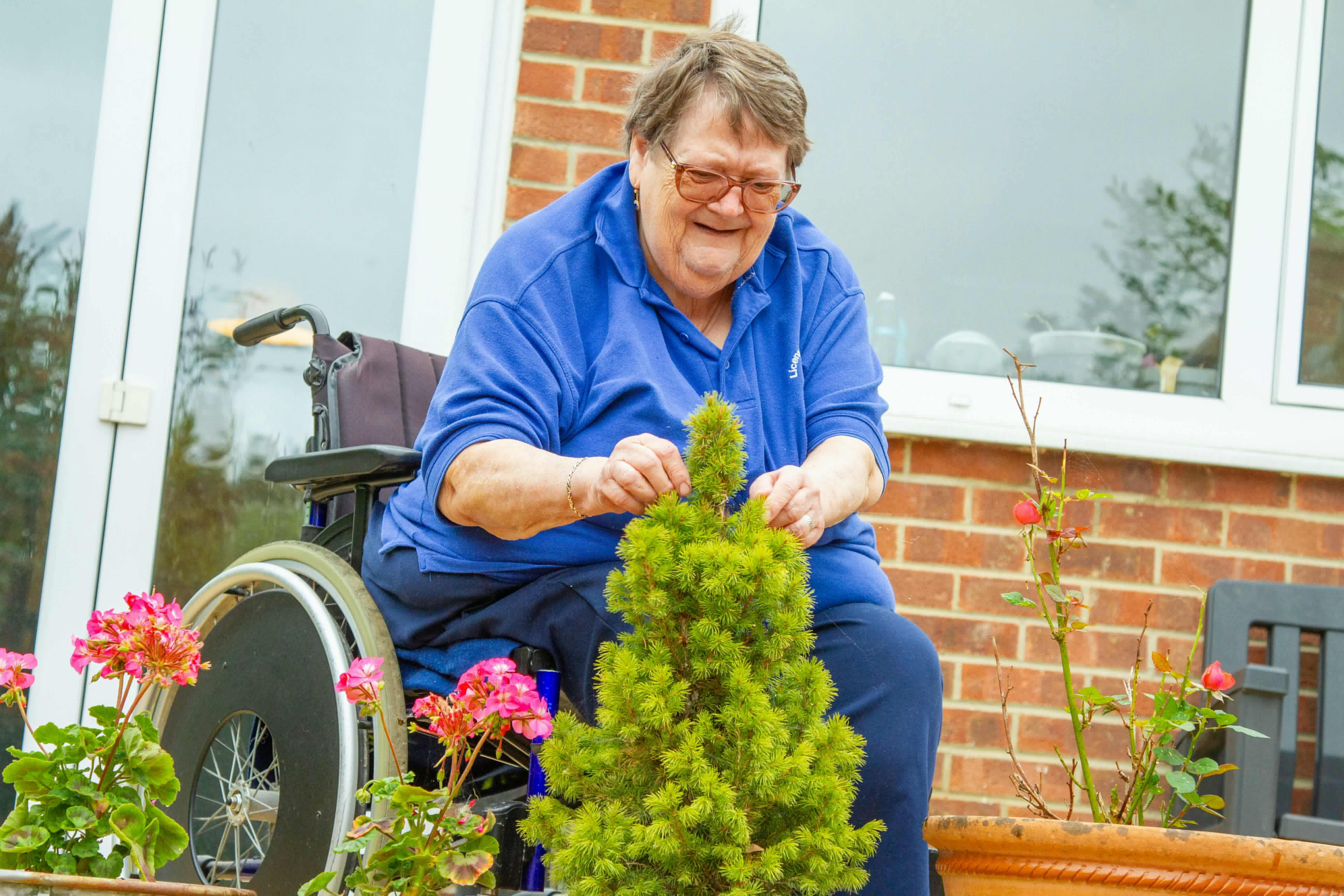 Senior enjoying gardening activities with support